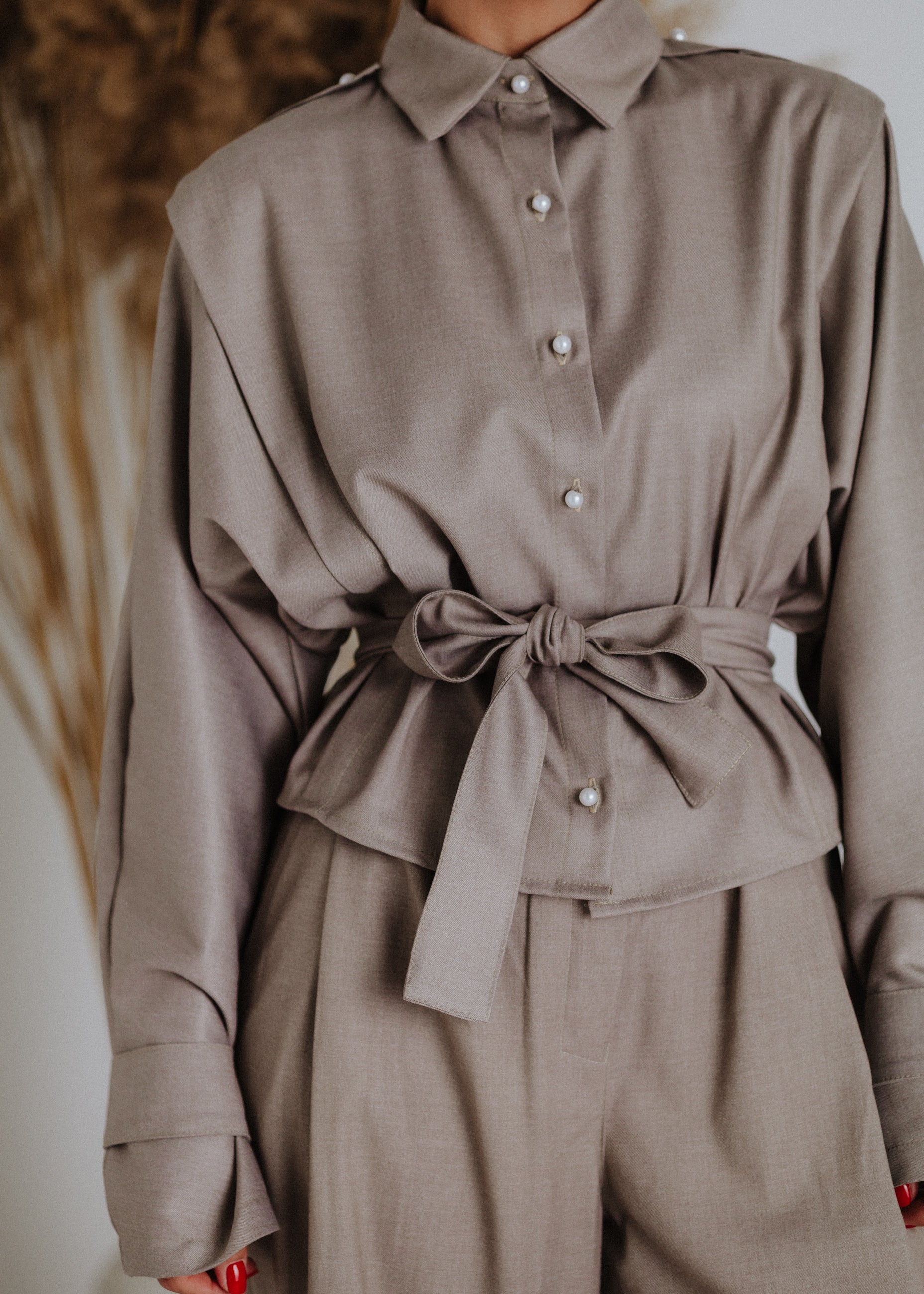 Taupe blouse with decorative straps