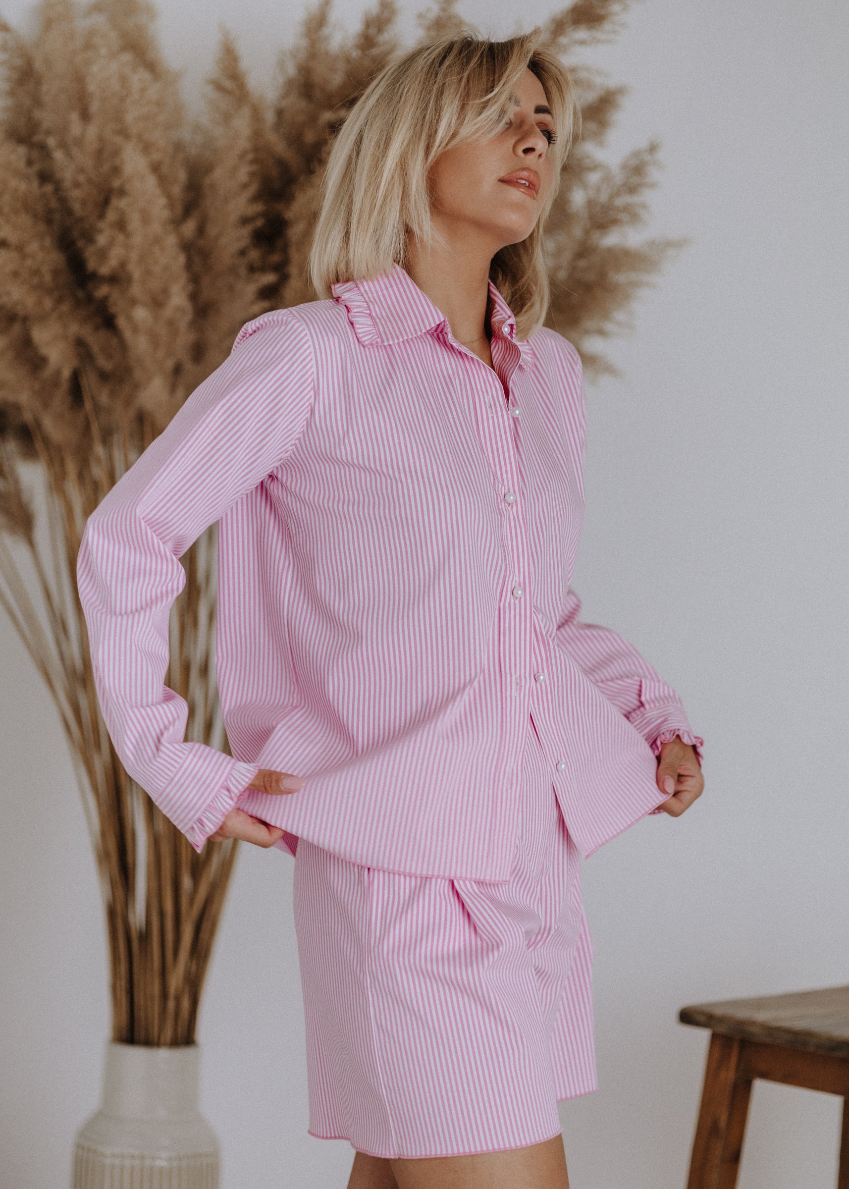 Striped shirt with ruffles in pink