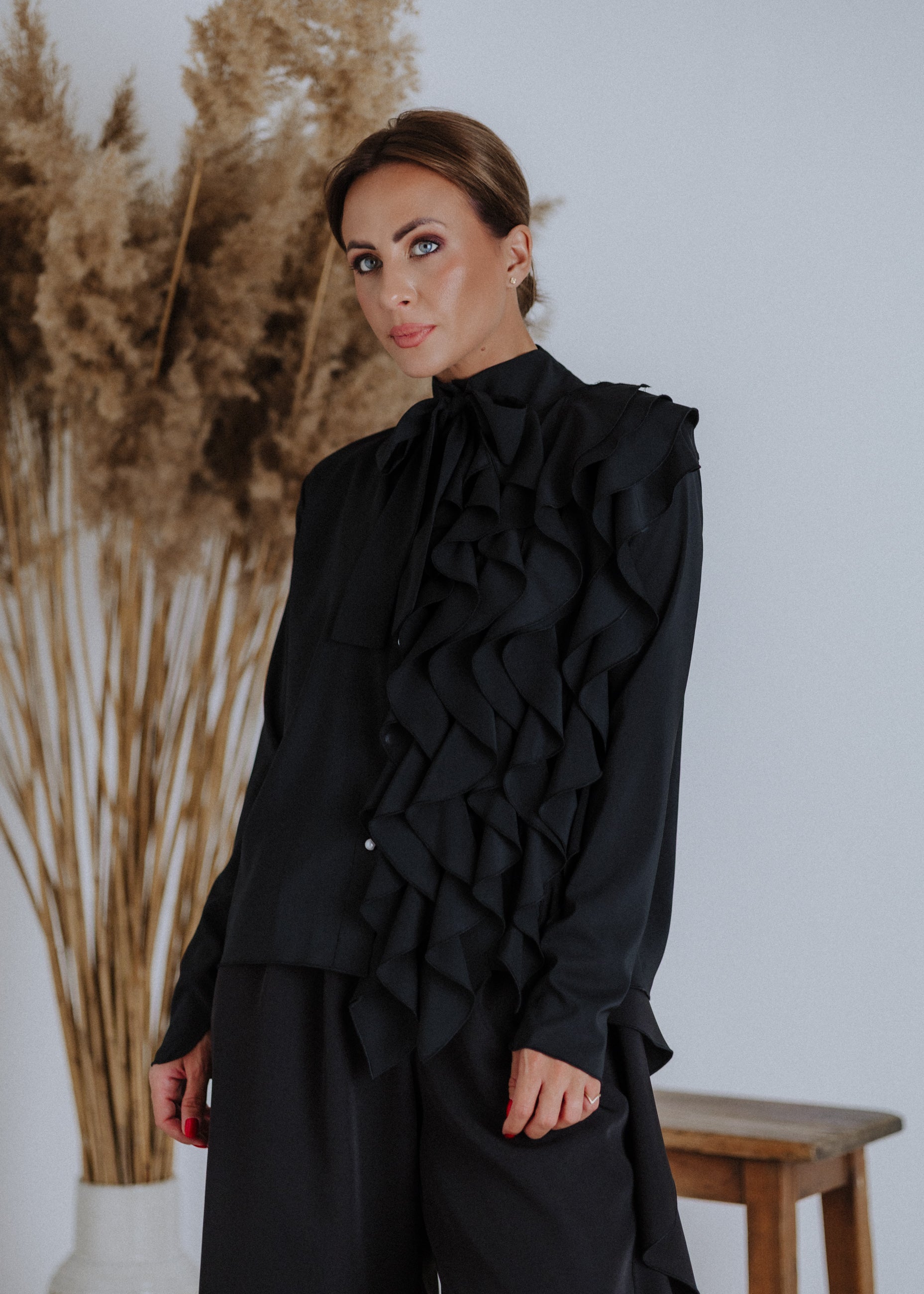 Black ruffled blouse with curls