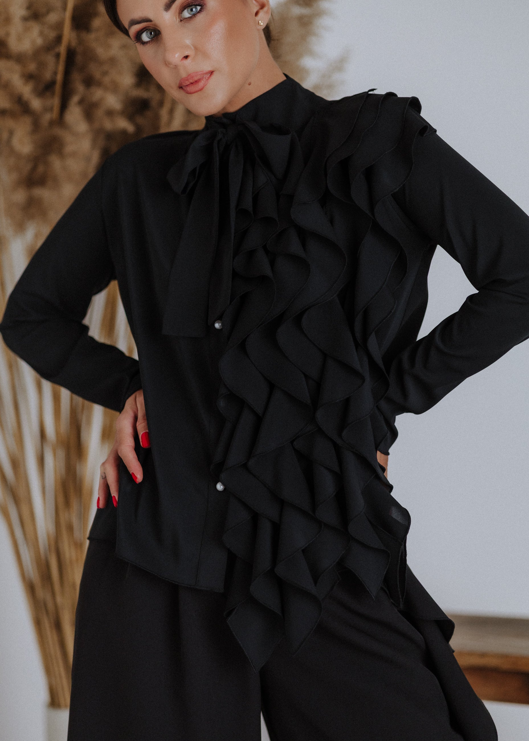 Black ruffled blouse with curls
