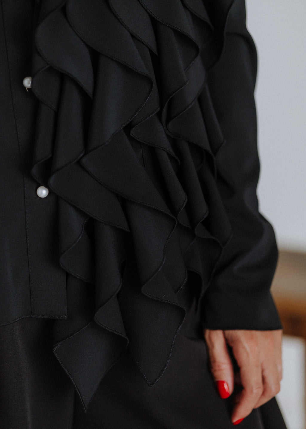 Black ruffled blouse with curls