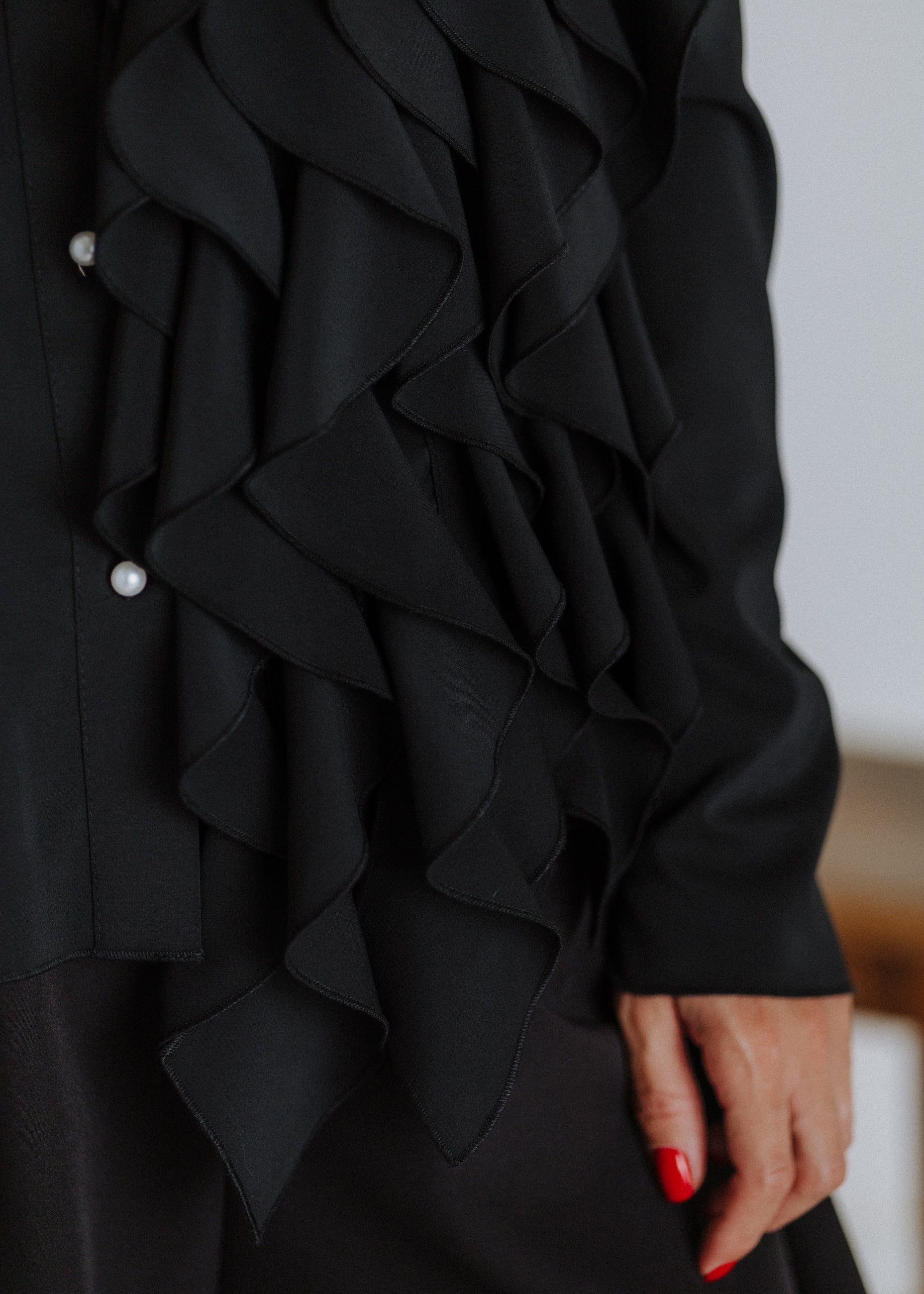 Black ruffled blouse with curls